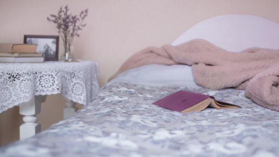 Image shows a bed with a a book laying on it